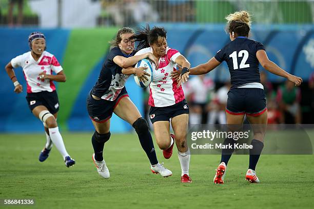 Yume Okuroda of Japan is tackled during a Women's Pool C rugby match between Great Britain and Japan on Day 1 of the Rio 2016 Olympic Games at...