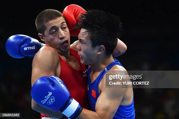 Tajikistan's Anvar Yunusov fights China's Shan Jun during the Men's Light match at the Rio 2016 Olympic Games at the Riocentro - Pavilion 6 in Rio de...