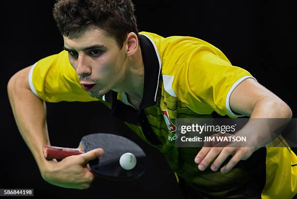 Poland's Jakub Dyjas hits a shot in his men's singles qualification round table tennis match at the Riocentro venue during the Rio 2016 Olympic Games...