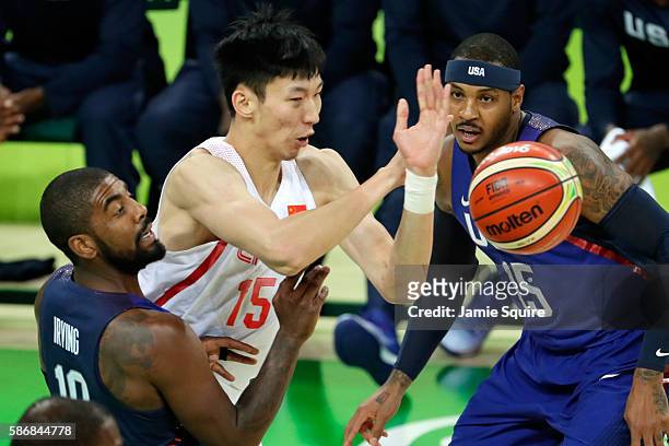Qi Zhou of China goes for the loose ball against Kyrie Irving and Carmelo Anthony of United States on Day 1 of the Rio 2016 Olympic Games at Carioca...