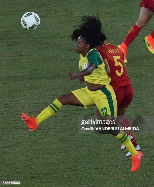 China player Wu Haiyan vies for the ball with South Africa player Jermaine Seoposenwe during the Rio 2016 Olympic Games women's First Round Group E...