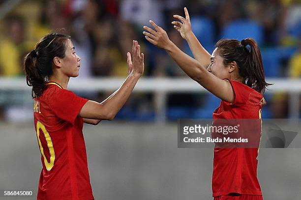Yasha Gu of China celebrates with teammate Li Yang after scoring China's first goal during the Women's Group E first round match between South Africa...