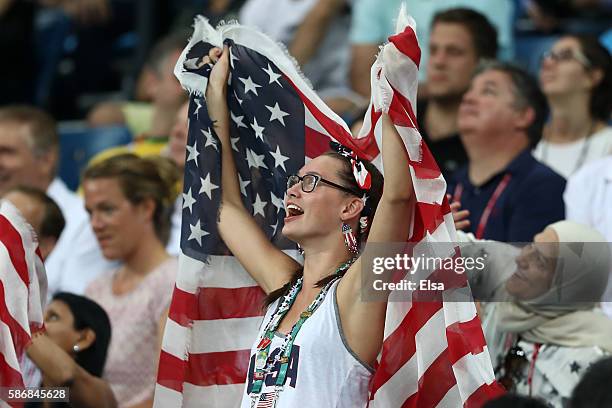 Fans hold up United States flags during the Men's Preliminary Round Group A match between the United States and China on Day 1 of the Rio 2016...