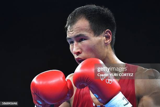 Kyrgyzstan's Erkin Adylbek Uulu fights his Colombian counterpart during the Men's Light Heavy match at the Rio 2016 Olympic Games at the Riocentro -...