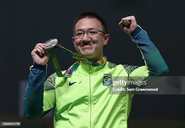 Felipe Almeida Wu of Brazil celebrates after winning the silver medal in the 10m Air Pistol Men's Finals on Day 1 of the Rio 2016 Olympic Games at...