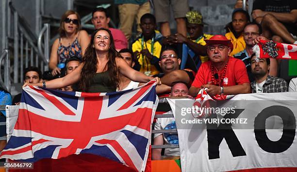 Briton fans cheer during a match at the Rio 2016 Olympic Games at the Riocentro Pavilion in Rio de Janeiro, on August 6, 2016. / AFP / Yuri CORTEZ