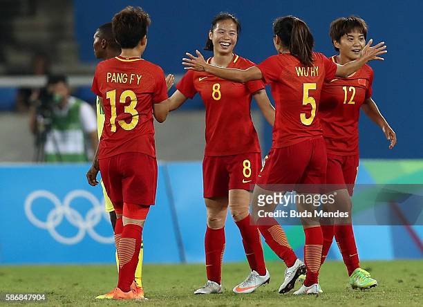 Ruyin Tan of China celebrates with teammate Haiyan Wu after scoring China's second goal during the Women's Group E first round match between South...