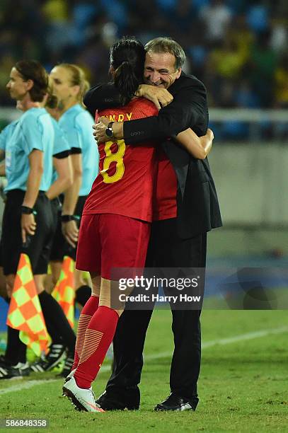 China Coach Bruno Bini embraces goalscorer Ruyin Tan following the Women's Group E first round match between South Africa and China PR on Day 1 of...