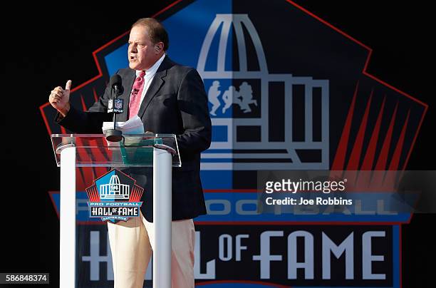 Chris Berman, ESPN sportscaster and event emcee, speaks during the NFL Hall of Fame Enshrinement Ceremony at the Tom Benson Hall of Fame Stadium on...