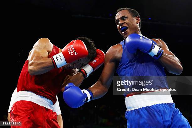 Juan Carlos Carrillo of Colombia exchanges blows with Erkin Adylbek Uulu of Kyrgyzstan during their Men's Heavy 81kg Preliminary bout on Day 1 of the...