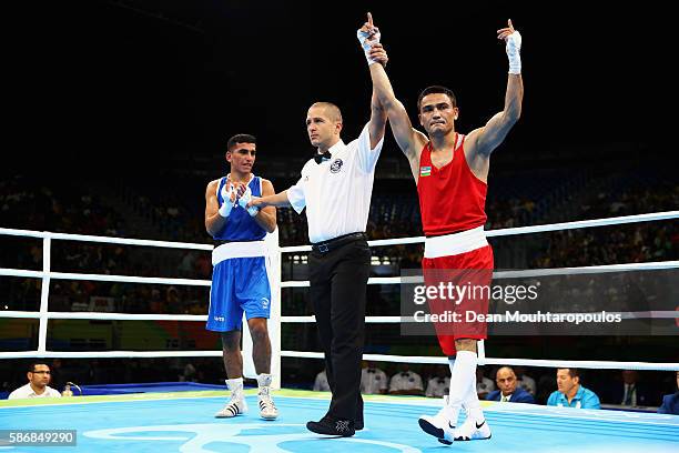 Hurshid Tojibaev of Uzbekistan celebrates victory over Hakan Eresker of Qatar after their Men's Light 60kg Preliminary bout on Day 1 of the Rio 2016...