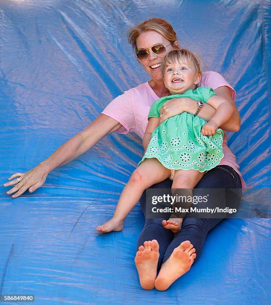 Autumn Phillips and Mia Tindall play on a bouncy castle slide as they attend day 2 of the Festival of British Eventing at Gatcombe Park on August 6,...