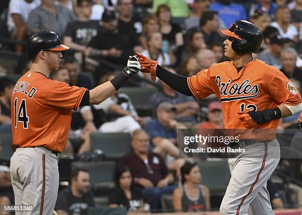 Manny Machado of the Baltimore Orioles is greeted by Nolan Reimold after scoring against the Chicago White Sox during the sixth inning on July 6,...