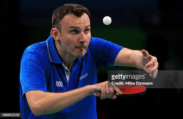 Adrian Crisan of Romania plays a Men's Singles first round match against Sharath Kamal Achanta of India on Day 1 of the Rio 2016 Olympic Games at...