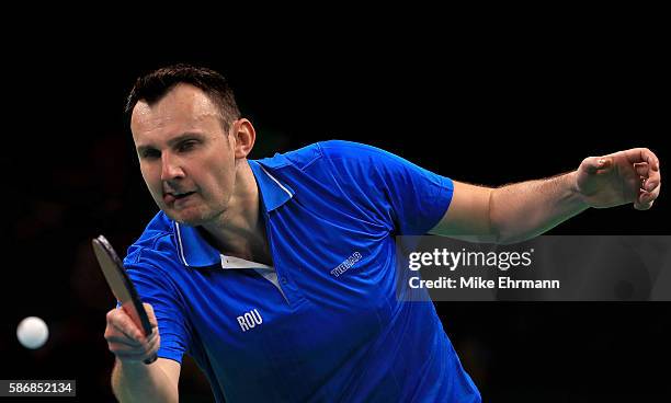 Adrian Crisan of Romania plays a Men's Singles first round match against Sharath Kamal Achanta of India on Day 1 of the Rio 2016 Olympic Games at...