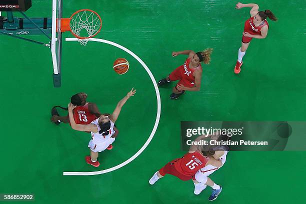 Hongpin Huang of China attempts a shot over Tamara Tatham of Canada during a Women's Basketball Preliminary Round game on Day 1 of the Rio 2016...