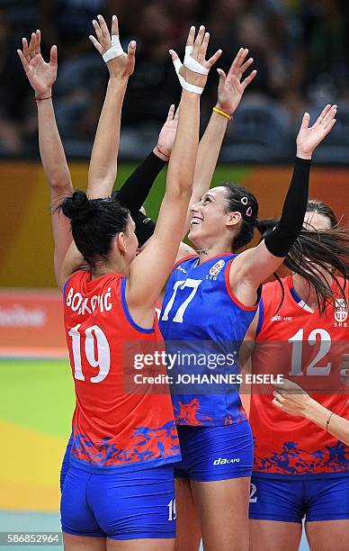 Serbia's Silvija Popovic jokes with Serbia's Tijana Boskovic ahead of the women's qualifying volleyball match between Serbia and Italy at the...