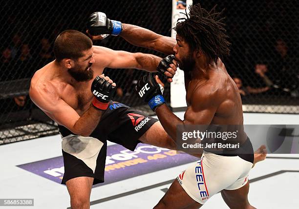 Dominique Steele punches Court McGee in their welterweight bout during the UFC Fight Night event at Vivint Smart Home Arena on August 6, 2016 in Salt...