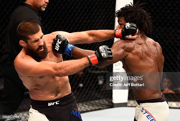 Dominique Steele punches Court McGee in their welterweight bout during the UFC Fight Night event at Vivint Smart Home Arena on August 6, 2016 in Salt...