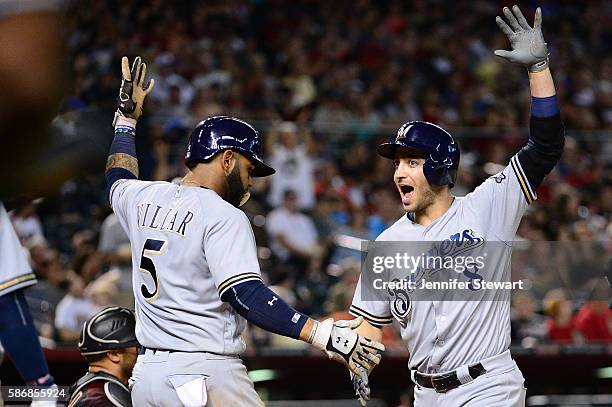 Ryan Braun of the Milwaukee Brewers celebrates with Jonathan Villar after Braun hit a three run home run against the Arizona Diamondbacks during the...