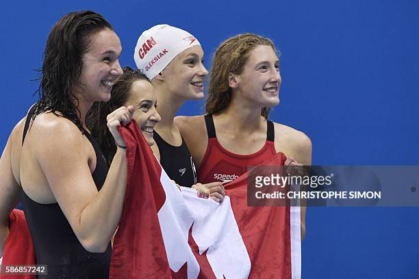 Team Canada, Canada's Sandrine Mainville, Canada's Chantal van Landeghem, Canada's Taylor Ruck and Canada's Penny Oleksiak celebrate after they won...