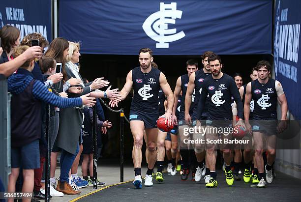 Andrew Walker of the Blues leads his side onto the field during the round 20 AFL match between the Carlton Blues and the St Kilda Saints at Melbourne...