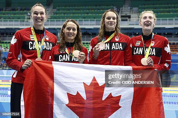 Team Canada, Canada's Sandrine Mainville, Canada's Chantal van Landeghem, Canada's Taylor Ruck and Canada's Penny Oleksiak pose with their bronze...