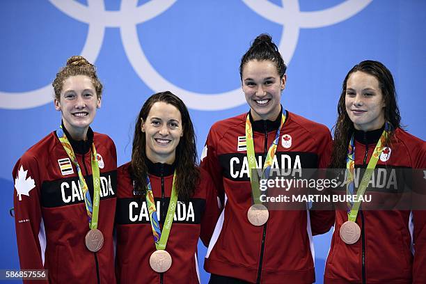 Team Canada, Canada's Sandrine Mainville, Canada's Chantal van Landeghem, Canada's Taylor Ruck and Canada's Penny Oleksiak pose with their bronze...