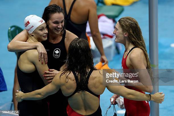 Sandrine Mainville, Chantal Van Landeghem, Taylor Ruck and Penny Oleksak of Canada celebrate winning Bronze medalist XXX poses during the medal...