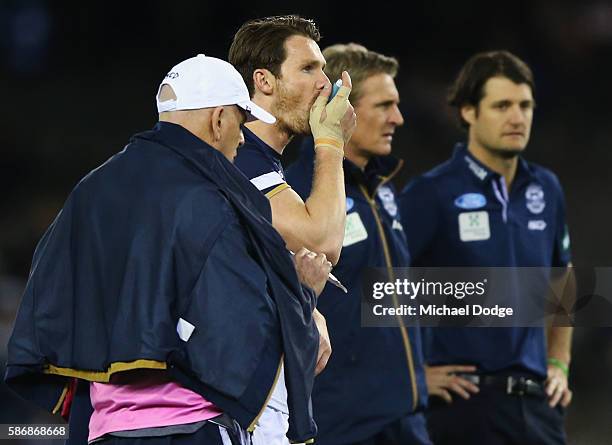Patrick Dangerfield of the Cats takes in some medication during the round 20 AFL match between the Geelong Cats and the Essendon Bombers at Etihad...