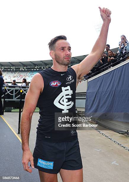 Andrew Walker of the Blues gestures to supporters in the crowd as he leaves the field after playing his final AFL match during the round 20 AFL match...