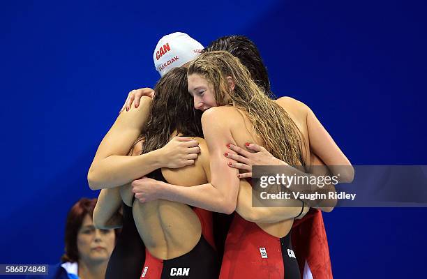 Sandrine Mainville, Penny Oleksiak, Chantel Van Landeghem and Taylor Ruck of Canada celebrate as they win Bronze in the Women's 4x100m Freestyle...