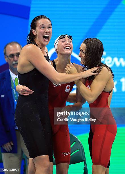 Chantel Van Landeghem , Taylor Ruck and Sandrine Mainville of Canada celebrate as they win Bronze in the Women's 4x100m Freestyle Final on Day 1 of...