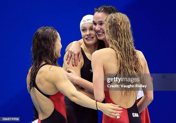 Sandrine Mainville, Penny Oleksiak, Chantel Van Landeghem and Taylor Ruck of Canada celebrate as they win Bronze in the Women's 4x100m Freestyle...