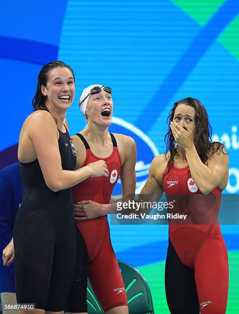 Chantel Van Landeghem , Taylor Ruck and Sandrine Mainville of Canada celebrate as they win Bronze in the Women's 4x100m Freestyle Final on Day 1 of...