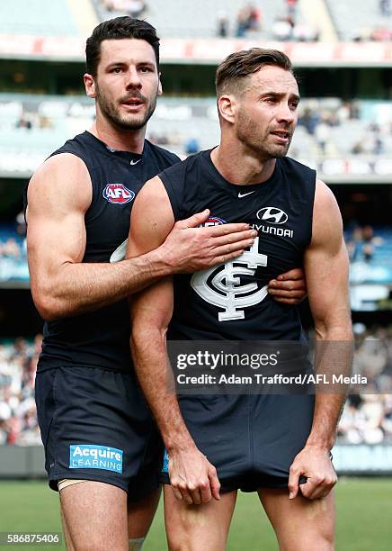 Andrew Walker of the Blues playing his final game is hugged by teammate Simon White of the Blues after the 2016 AFL Round 20 match between the...