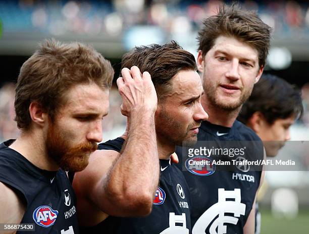 Andrew Walker of the Blues looks on after his final game with Zach Tuohy and Sam Rowe of the Blues during the 2016 AFL Round 20 match between the...