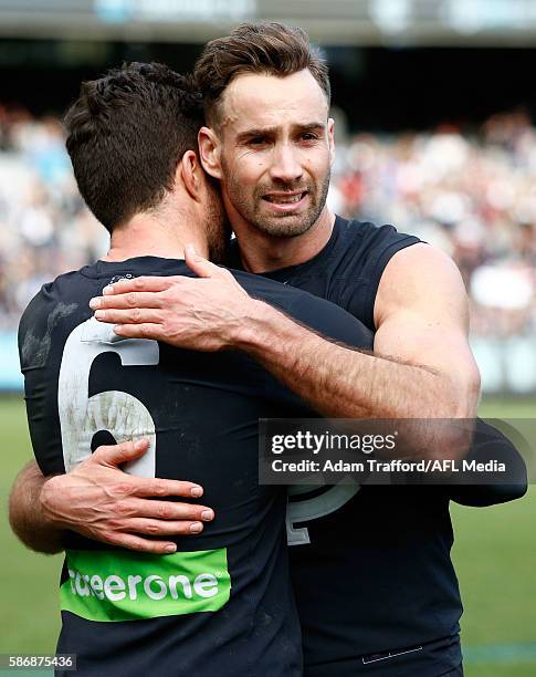 Andrew Walker of the Blues playing his final game hugs teammate Kade Simpson of the Blues after the 2016 AFL Round 20 match between the Carlton Blues...