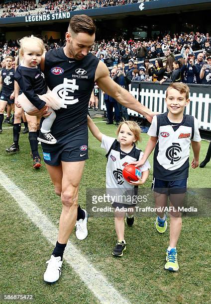 Andrew Walker of the Blues walks out for his last game with his family during the 2016 AFL Round 20 match between the Carlton Blues and the St Kilda...