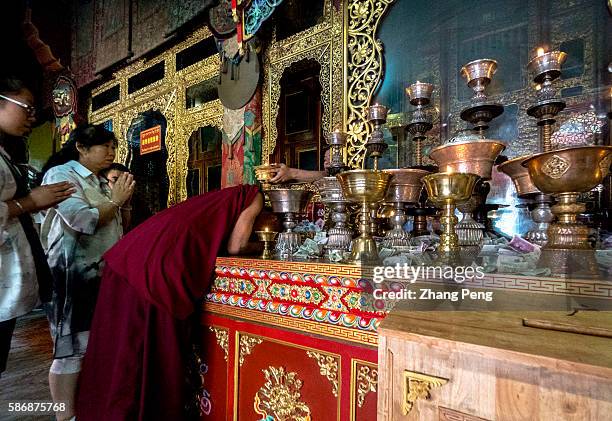 Lama monk is receiving his abhiseca ritual. Kumbum Monastery is one of the two most important Tibetan Buddhist monasteries outside Tibet. In order to...