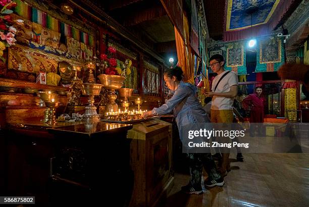 Pious pilgrims offer the butter lamps to Buddha. Kumbum Monastery is one of the two most important Tibetan Buddhist monasteries outside Tibet. In...