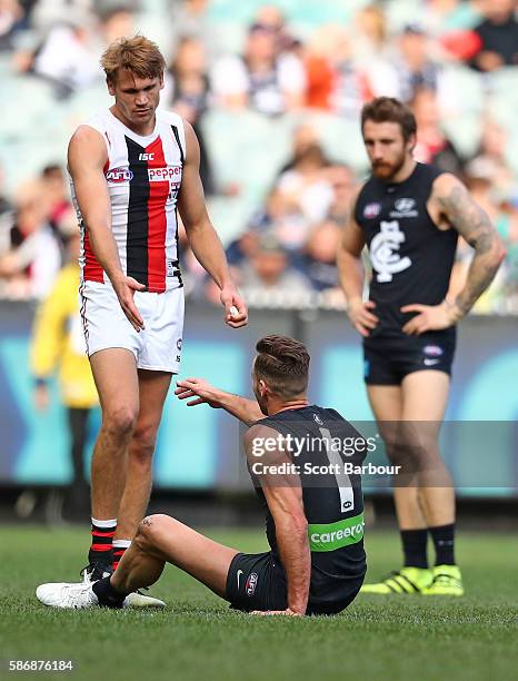 Andrew Walker of the Blues is helped to his feet by Sam Gilbert of the Saints at the full time siren as he leaves the field after playing his final...