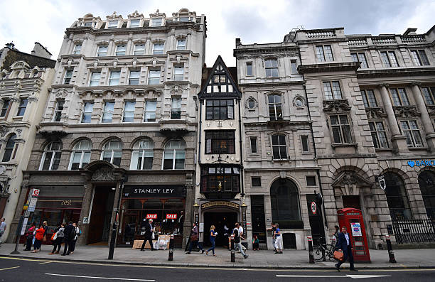 People walk past Ye Olde Cock Tavern, a pub once popular with journalists, in Fleet Street, on August 5, 2016 in London, England. The last two...