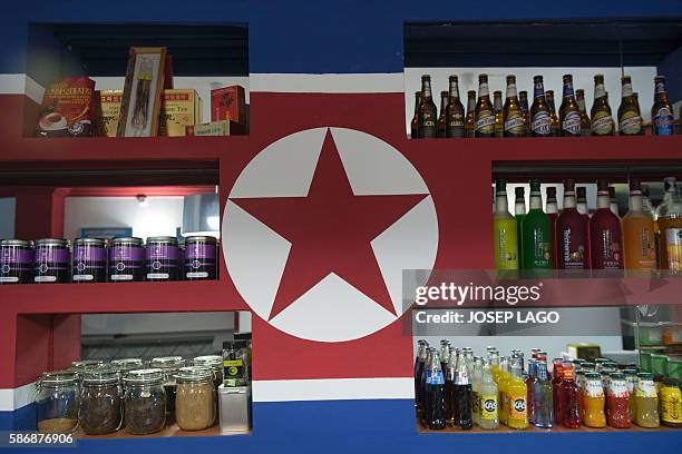 Daniel BOSQUE - Bottles line the shelves of the Pyongyangcafe dedicated to friends of the Democratic People's Republic of Korea on July 30, 2016 in...