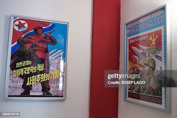 Daniel BOSQUE - Original North Korean propoganda posters decorate the wall of the Pyongyangcafe dedicated to friends of the Democratic People's...