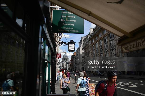 People walk past Ye Olde Cheshire Cheese pub, formerly a famous haunt for journalists, in Fleet Street, on August 5, 2016 in London, England. The...