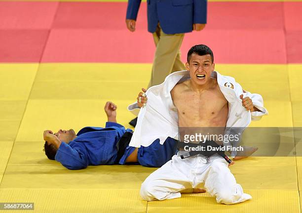 Diyorbek Urozboev of Uzbekistan celebrates defeating Amiran Papinashvili of Georgia for the under 60kg bronze medal during day 1 of the 2016 Rio...