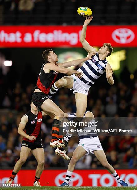 Zac Smith of the Cats and Matthew Leuenberger of the Bombers compete in a ruck contest during the 2016 AFL Round 20 match between the Geelong Cats...