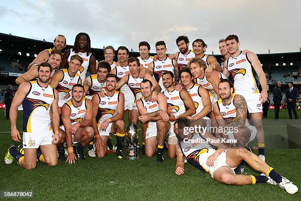 The Eagles pose with the Western Derby trophy after winning the round 20 AFL match between the Fremantle Dockers and the West Coast Eagles at Domain...