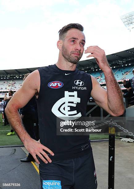 Andrew Walker of the Blues lreacts as he leaves the field after playing his final AFL match during the round 20 AFL match between the Carlton Blues...